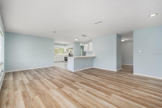 801 Lamont Pl, Temple Terrace, FL 33617 - unfurnished living room with light wood-style flooring and recessed lighting