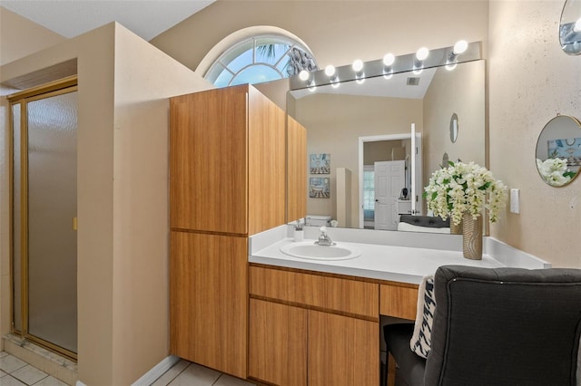10032 Basin St, New Port Richey, FL 34655 - bathroom featuring tile patterned floors, a stall shower, vanity, and vaulted ceiling