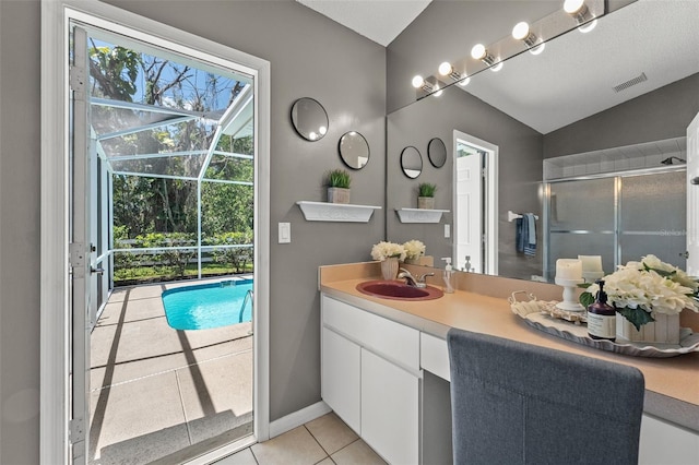 10032 Basin St, New Port Richey, FL 34655 - bathroom featuring vanity, a shower with shower door, tile patterned flooring, and vaulted ceiling