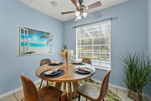 10032 Basin St, New Port Richey, FL 34655 - dining space with light tile patterned flooring, a ceiling fan, and a textured ceiling