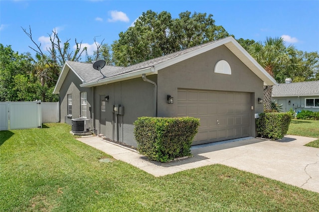 10032 Basin St, New Port Richey, FL 34655 - view of side of home featuring stucco siding, concrete driveway, an attached garage, and a gate