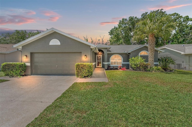 10032 Basin St, New Port Richey, FL 34655 - single story home featuring an attached garage, stucco siding, driveway, and a lawn