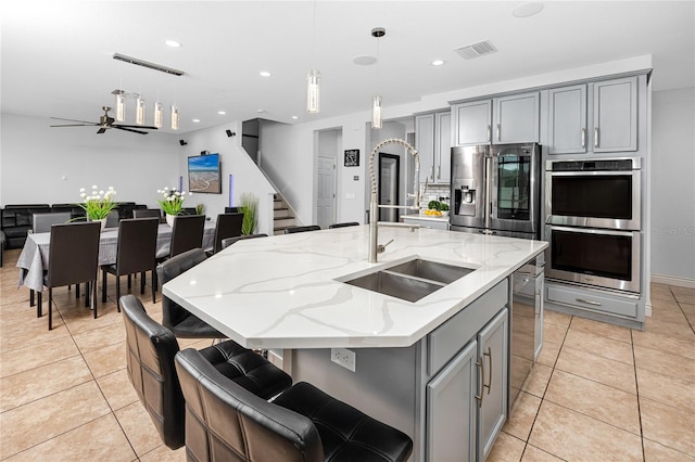 1601 Fox Grape Loop, Lutz, FL 33558 - kitchen featuring gray cabinetry, stainless steel appliances, light tile patterned floors, and recessed lighting