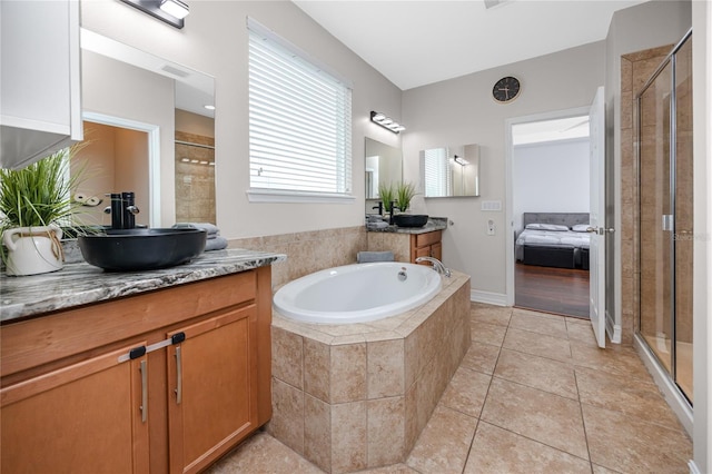 1601 Fox Grape Loop, Lutz, FL 33558 - ensuite bathroom featuring a stall shower, two vanities, a garden tub, and tile patterned floors