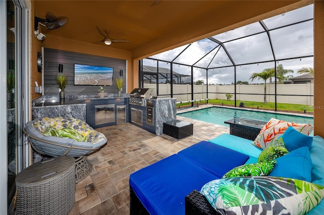 1601 Fox Grape Loop, Lutz, FL 33558 - view of patio featuring an outdoor kitchen, a ceiling fan, glass enclosure, and outdoor lounge area