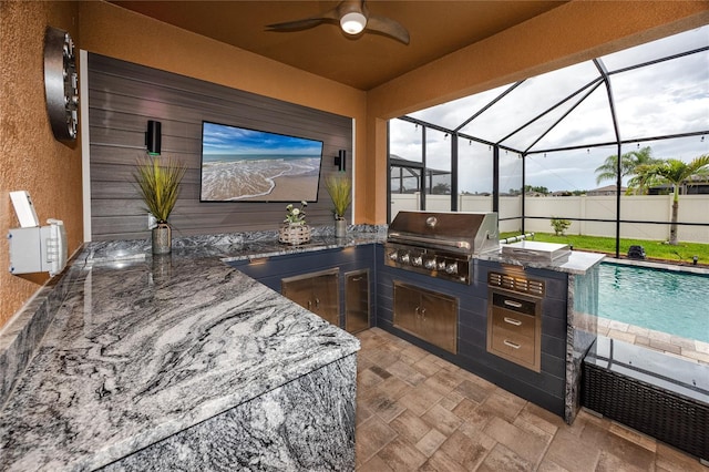 1601 Fox Grape Loop, Lutz, FL 33558 - view of patio with an outdoor kitchen, a ceiling fan, and a lanai