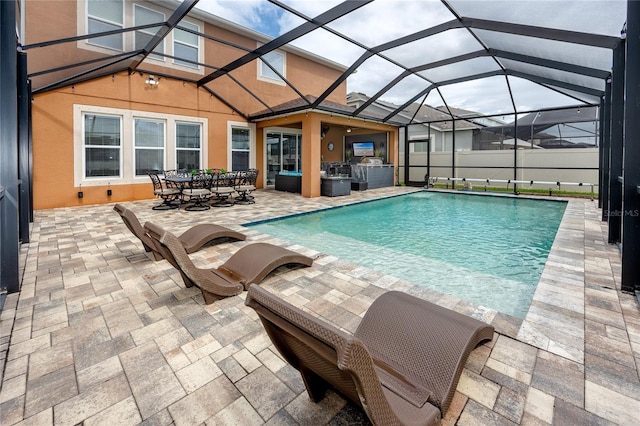 1601 Fox Grape Loop, Lutz, FL 33558 - swimming pool with exterior kitchen, a patio area, glass enclosure, and outdoor dining space