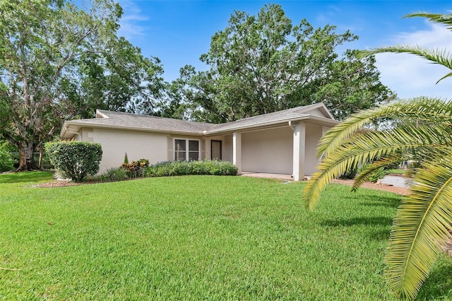 2875 Lomond Dr, Palm Harbor, FL 34684 - view of front of house featuring stucco siding and a front lawn