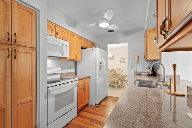 2875 Lomond Dr, Palm Harbor, FL 34684 - kitchen with white appliances, wood finished floors, a ceiling fan, and stone countertops