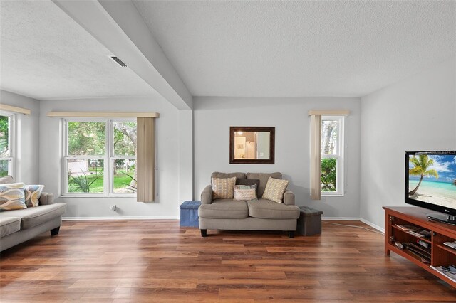 2875 Lomond Dr, Palm Harbor, FL 34684 - living area featuring a textured ceiling, wood finished floors, and healthy amount of natural light