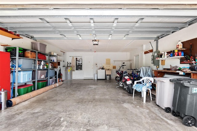 2875 Lomond Dr, Palm Harbor, FL 34684 - garage with a garage door opener, separate washer and dryer, electric panel, and water heater