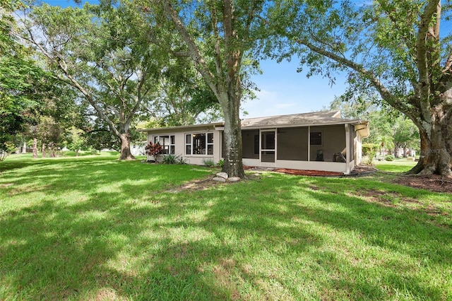 2875 Lomond Dr, Palm Harbor, FL 34684 - back of house featuring a sunroom and a lawn