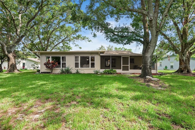 2875 Lomond Dr, Palm Harbor, FL 34684 - rear view of property with a lawn, a sunroom, and stucco siding
