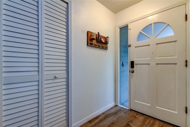 7320 Hideaway Trl, New Port Richey, FL 34655 - entrance foyer with dark wood finished floors and a textured ceiling