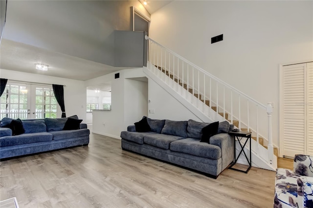 7320 Hideaway Trl, New Port Richey, FL 34655 - living room with a towering ceiling, french doors, stairway, and wood finished floors