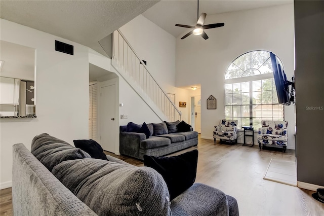 7320 Hideaway Trl, New Port Richey, FL 34655 - living area featuring stairway, wood finished floors, a ceiling fan, and high vaulted ceiling