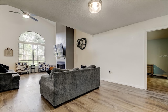 7320 Hideaway Trl, New Port Richey, FL 34655 - living room featuring wood finished floors, ceiling fan, a textured ceiling, and lofted ceiling