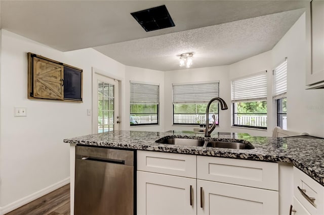7320 Hideaway Trl, New Port Richey, FL 34655 - kitchen with dishwasher, dark wood finished floors, white cabinets, dark stone counters, and a textured ceiling