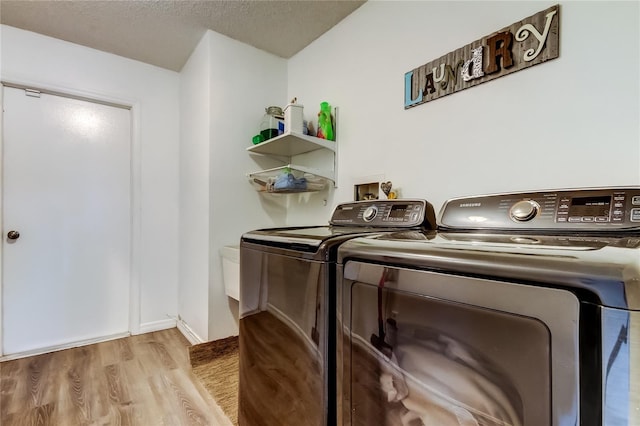 7320 Hideaway Trl, New Port Richey, FL 34655 - laundry area with independent washer and dryer, wood finished floors, and a textured ceiling