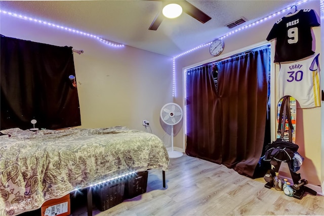 7320 Hideaway Trl, New Port Richey, FL 34655 - bedroom with wood finished floors and a ceiling fan