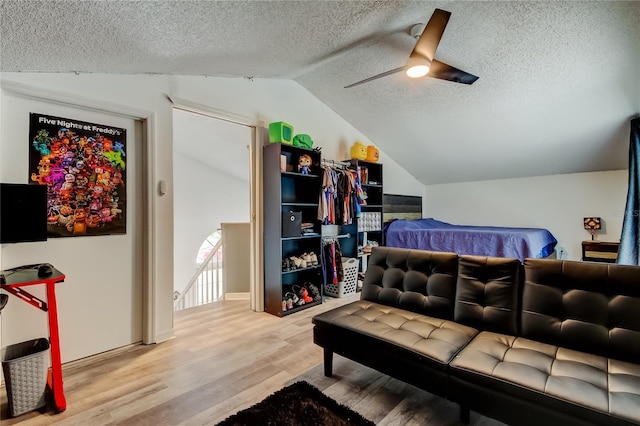 7320 Hideaway Trl, New Port Richey, FL 34655 - bedroom with vaulted ceiling, a textured ceiling, wood finished floors, and ceiling fan
