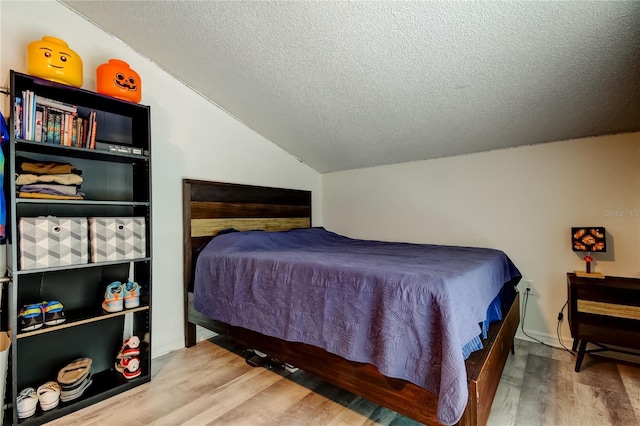 7320 Hideaway Trl, New Port Richey, FL 34655 - bedroom featuring wood finished floors, a textured ceiling, and vaulted ceiling