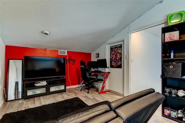 7320 Hideaway Trl, New Port Richey, FL 34655 - living room featuring a textured ceiling, wood finished floors, lofted ceiling, and an office area