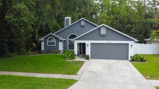 7320 Hideaway Trl, New Port Richey, FL 34655 - view of front of property featuring an attached garage, concrete driveway, and a chimney