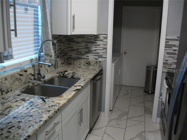 12411 Brookside St, Spring Hill, FL 34609 - kitchen featuring light marble finish floors, dishwasher, white cabinetry, decorative backsplash, and light stone counters