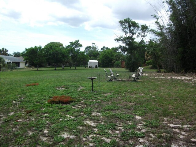 12411 Brookside St, Spring Hill, FL 34609 - view of green lawn with a shed
