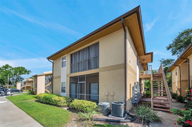 10195 Sailwinds Blvd N Unit 208, Largo, FL 33773 - back of property with stairway and stucco siding