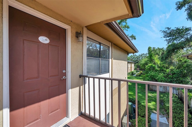 10195 Sailwinds Blvd N Unit 208, Largo, FL 33773 - doorway to property featuring stucco siding and a balcony