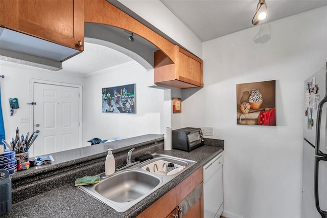 10195 Sailwinds Blvd N Unit 208, Largo, FL 33773 - kitchen with white appliances, dark countertops, and brown cabinets