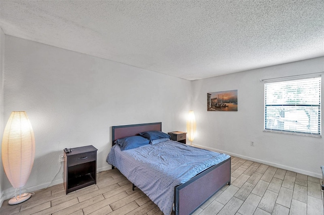 10195 Sailwinds Blvd N Unit 208, Largo, FL 33773 - bedroom with wood tiled floors and a textured ceiling
