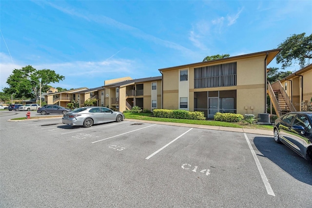 10195 Sailwinds Blvd N Unit 208, Largo, FL 33773 - view of property featuring uncovered parking and stairs