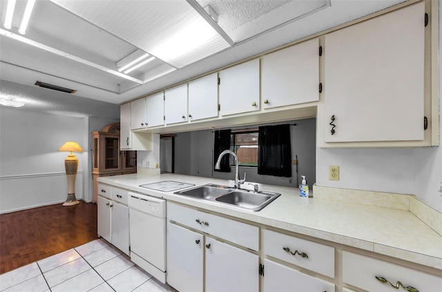 4143 Gray Squirrel Ln, New Port Richey, FL 34653 - kitchen featuring dishwasher, light countertops, and white cabinetry
