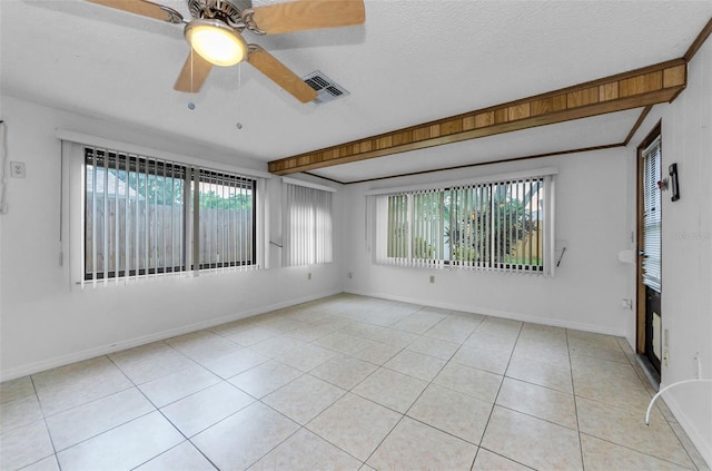 4143 Gray Squirrel Ln, New Port Richey, FL 34653 - empty room with plenty of natural light, light tile patterned floors, ceiling fan, and a textured ceiling