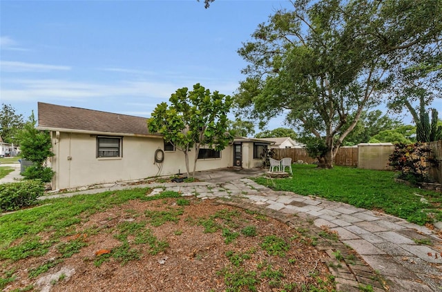 4143 Gray Squirrel Ln, New Port Richey, FL 34653 - back of house with a fenced backyard, stucco siding, and a patio