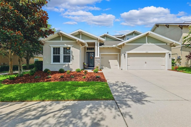 6007 Quartz Lake Way, Lithia, FL 33547 - craftsman house with stucco siding, driveway, an attached garage, and a front lawn