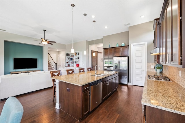 6007 Quartz Lake Way, Lithia, FL 33547 - kitchen featuring appliances with stainless steel finishes, a breakfast bar, open floor plan, dark wood-style flooring, and a ceiling fan
