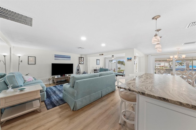 4252 Floramar Ter, New Port Richey, FL 34652 - living area featuring light wood-style flooring, a chandelier, and recessed lighting