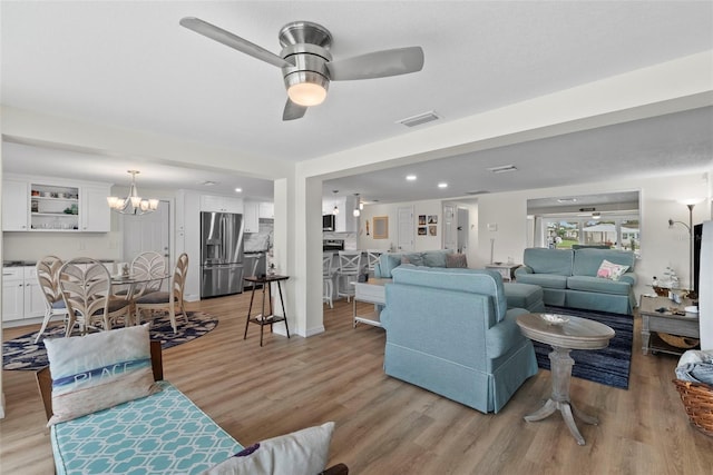 4252 Floramar Ter, New Port Richey, FL 34652 - living room with light wood-type flooring, a chandelier, and a ceiling fan