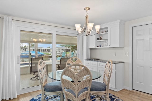 4252 Floramar Ter, New Port Richey, FL 34652 - dining area with a chandelier and light wood-style flooring