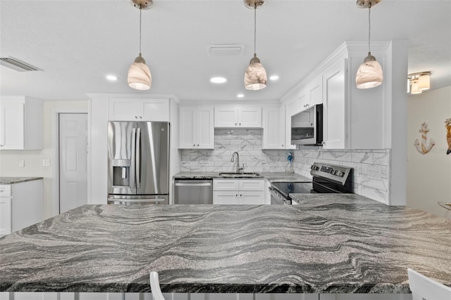 4252 Floramar Ter, New Port Richey, FL 34652 - kitchen with stainless steel appliances, decorative backsplash, dark stone counters, and recessed lighting
