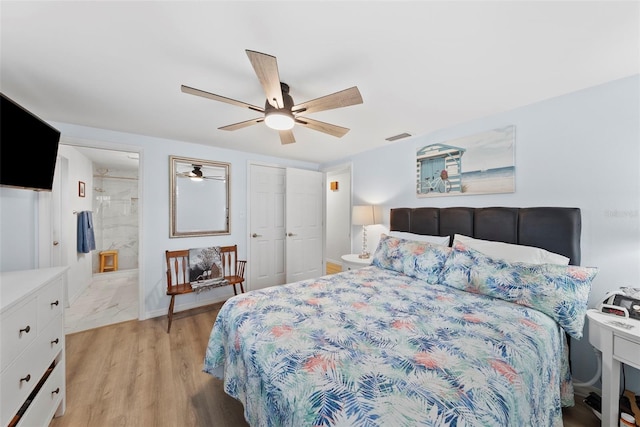 4252 Floramar Ter, New Port Richey, FL 34652 - bedroom featuring a ceiling fan, connected bathroom, light wood-style flooring, and a closet