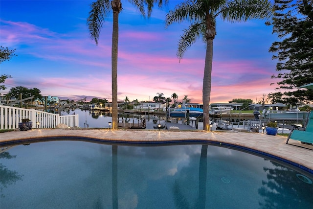 4252 Floramar Ter, New Port Richey, FL 34652 - pool at dusk with an outdoor pool, a boat dock, and boat lift