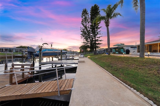 4252 Floramar Ter, New Port Richey, FL 34652 - dock area featuring boat lift, a lawn, and a water view