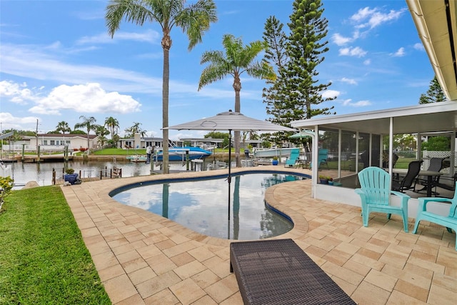 4252 Floramar Ter, New Port Richey, FL 34652 - swimming pool with a sunroom, a patio area, and a water view