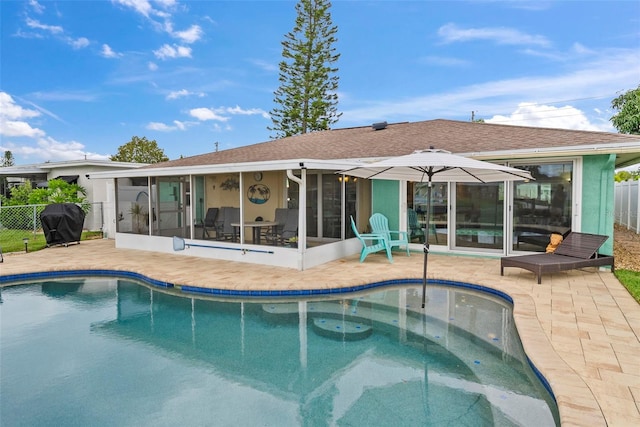 4252 Floramar Ter, New Port Richey, FL 34652 - rear view of property featuring a sunroom, a patio area, a shingled roof, and stucco siding