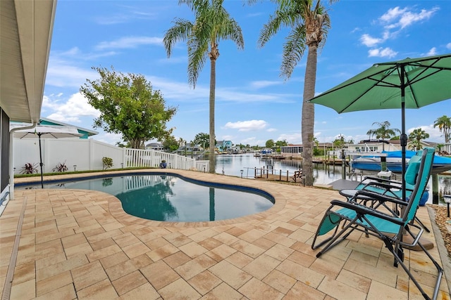4252 Floramar Ter, New Port Richey, FL 34652 - view of swimming pool featuring a patio area, a water view, and a fenced backyard